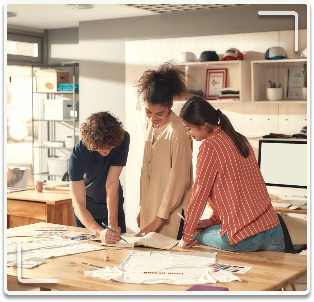 Fashion students collaborating around a studio table